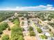 Scenic aerial view of a neighborhood featuring lush trees interspersed between well-kept homes at 13546 Biscayne Grove Ln, Grand Island, FL 32735