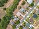 Overhead photo of homes featuring lush backyards, solar panels, and refreshing swimming pools under the bright sunshine at 13546 Biscayne Grove Ln, Grand Island, FL 32735