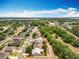 Aerial view of a community, with neat landscaping and a serene lake in the distance, bathed in a beautiful sky at 13546 Biscayne Grove Ln, Grand Island, FL 32735