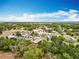 Aerial view of a quiet residential neighborhood with mature trees and well-maintained lawns, under a bright sky at 13546 Biscayne Grove Ln, Grand Island, FL 32735