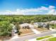 Aerial view showcasing the home, lush landscaping, and neighborhood setting at 13546 Biscayne Grove Ln, Grand Island, FL 32735