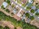 A neighborhood with solar panels, and swimming pools, amidst green lawns and trees, seen from an aerial perspective at 13546 Biscayne Grove Ln, Grand Island, FL 32735