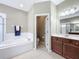 Bathroom with glass enclosed shower, soaking tub, door to the water closet and double sink vanity at 13546 Biscayne Grove Ln, Grand Island, FL 32735