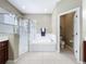 Bathroom with glass enclosed shower, soaking tub and door to the water closet at 13546 Biscayne Grove Ln, Grand Island, FL 32735
