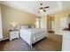 Bedroom featuring wood-look floors, a comfortable bed, and a tray ceiling, creating a relaxing and inviting retreat at 13546 Biscayne Grove Ln, Grand Island, FL 32735