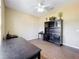 Well-lit bedroom with dark wood-look flooring, ceiling fan, and dark cabinets at 13546 Biscayne Grove Ln, Grand Island, FL 32735