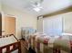 Cozy bedroom with wood-look flooring, ceiling fan, and neutral walls at 13546 Biscayne Grove Ln, Grand Island, FL 32735