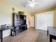 Spacious bedroom featuring wood-look floors, closet, and a stylish black wooden desk adding a touch of sophistication at 13546 Biscayne Grove Ln, Grand Island, FL 32735