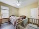 Bright bedroom featuring a ceiling fan, wood-look flooring, and a window at 13546 Biscayne Grove Ln, Grand Island, FL 32735