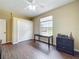Bedroom featuring wood-look flooring, closet, and window providing natural light, creating a welcoming atmosphere at 13546 Biscayne Grove Ln, Grand Island, FL 32735