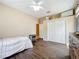 Bedroom featuring wood-look floors, a comfortable bed, and a closet, providing a peaceful and inviting space at 13546 Biscayne Grove Ln, Grand Island, FL 32735
