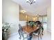 Cozy dining room showcasing a classic table and chairs with views of the living area at 13546 Biscayne Grove Ln, Grand Island, FL 32735