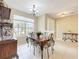 Inviting dining room showcases a dark wooden table with detailed chairs, and a window with natural light at 13546 Biscayne Grove Ln, Grand Island, FL 32735