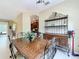 View of dining room with wooden table and decorative wrought iron hutch, showcasing a stylish space for meals and gatherings at 13546 Biscayne Grove Ln, Grand Island, FL 32735