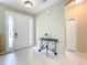Bright foyer features tile flooring, a white front door, and a decorative console table, creating a welcoming entrance at 13546 Biscayne Grove Ln, Grand Island, FL 32735