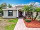 Welcoming front entrance with a dark wood door, decorative columns, and well-kept landscaping, offering curb appeal at 13546 Biscayne Grove Ln, Grand Island, FL 32735