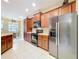 Spacious kitchen with wood cabinets, stainless steel appliances and eat-in dining area at 13546 Biscayne Grove Ln, Grand Island, FL 32735