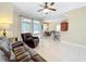 Spacious living room with a view of the outdoor patio, kitchen bar and dining area, ideal for entertainment and relaxation at 13546 Biscayne Grove Ln, Grand Island, FL 32735