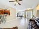 Open concept living space showcasing the kitchen bar, dining area, and front door, with tile flooring throughout at 13546 Biscayne Grove Ln, Grand Island, FL 32735