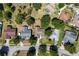 Aerial view displays an array of beautiful homes on well-kept lawns in a lush, tree-lined neighborhood at 14421 Pine Cone Trl, Clermont, FL 34711