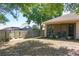 Lush backyard with mature trees, a screened patio, and wooden fencing at 14421 Pine Cone Trl, Clermont, FL 34711