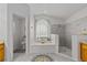 Bright bathroom with a soaking tub, walk-in shower, and tiled floors at 14421 Pine Cone Trl, Clermont, FL 34711