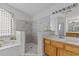 Bright bathroom showcasing a tiled walk-in shower and a luxurious soaking tub at 14421 Pine Cone Trl, Clermont, FL 34711
