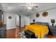 Spacious bedroom featuring wood floors, ceiling fan, and elegant decor at 14421 Pine Cone Trl, Clermont, FL 34711