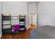 Bright bedroom featuring wood floors, a desk, and modern decor at 14421 Pine Cone Trl, Clermont, FL 34711