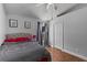 Cozy bedroom with wood floors, a ceiling fan, and a window with natural light at 14421 Pine Cone Trl, Clermont, FL 34711