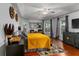 Bright bedroom features a ceiling fan, wood floors, and large windows at 14421 Pine Cone Trl, Clermont, FL 34711