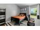 Bedroom with a black wood frame bed, modern decor, and a large window at 14421 Pine Cone Trl, Clermont, FL 34711