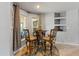 Cozy breakfast nook bathed in natural light, featuring a round glass table and stylish barstools at 14421 Pine Cone Trl, Clermont, FL 34711