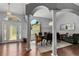 Elegant dining room with hardwood floors, stately columns, chandelier and lots of natural light at 14421 Pine Cone Trl, Clermont, FL 34711