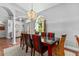 Stylish dining room with a dark wood table, decorative chandelier and comfortable seating for memorable gatherings at 14421 Pine Cone Trl, Clermont, FL 34711