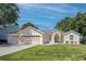 Charming single-Gathering home with a well-manicured lawn, a three-car garage and inviting curb appeal at 14421 Pine Cone Trl, Clermont, FL 34711