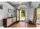 Warm and inviting foyer with hardwood flooring, a decorative cabinet and lots of natural light at 14421 Pine Cone Trl, Clermont, FL 34711