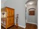 Inviting hallway featuring wood floors and an archway at 14421 Pine Cone Trl, Clermont, FL 34711