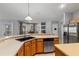 Kitchen featuring stainless steel appliances, light countertops, wood cabinets, and tile flooring at 14421 Pine Cone Trl, Clermont, FL 34711