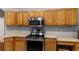 Updated kitchen showcasing stainless steel appliances, wood cabinetry and light countertops at 14421 Pine Cone Trl, Clermont, FL 34711