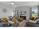 Bright living room with modern decor, comfortable seating, vaulted ceilings, and hardwood floors at 14421 Pine Cone Trl, Clermont, FL 34711