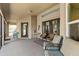Relaxing covered patio featuring comfortable seating and neutral tones at 14421 Pine Cone Trl, Clermont, FL 34711