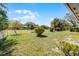 Expansive backyard featuring an open green lawn, mature trees, and a fenced perimeter at 16 Pine Run, Haines City, FL 33844