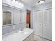 Well-lit bathroom featuring marble countertops, a large mirror and ample storage with double door closet at 16 Pine Run, Haines City, FL 33844