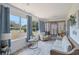 Enclosed porch with comfortable seating and large windows offering views of the expansive backyard at 16 Pine Run, Haines City, FL 33844
