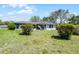 Charming one-story home featuring a screened-in porch and well-maintained landscaping in a spacious yard at 16 Pine Run, Haines City, FL 33844