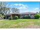 Inviting single-story brick home with blue shutters, an attached garage, and a lush green lawn at 16 Pine Run, Haines City, FL 33844