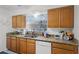 This kitchen boasts wood cabinets, granite countertops, stainless steel appliances, and a window over the sink at 16 Pine Run, Haines City, FL 33844