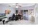Relaxing music room featuring a piano, computer, and sliding doors to an enclosed porch at 16 Pine Run, Haines City, FL 33844