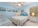 Well-lit bedroom with beach-themed decor, including a wicker bed frame and nautical accents at 16730 Beauclaire Ct, Tavares, FL 32778